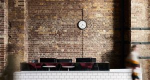 An exposed brick wall as a backdrop against modern furniture at the flexible office space at East Side in Kings Cross Station