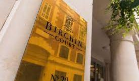 The brass nameplate on the exterior of the Birchin Court office space in Bank