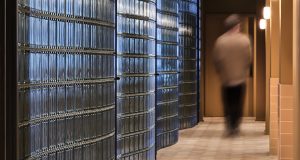 A corridor with wavey glass leading to offices