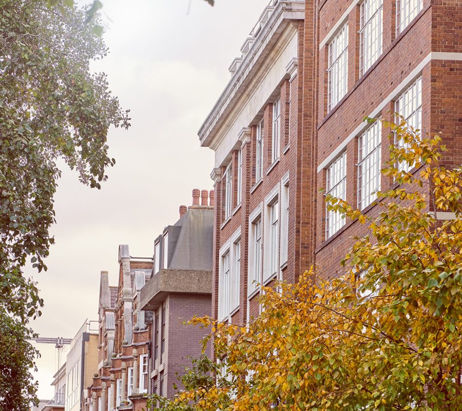 An exterior shot of the luxury office space in Fitzrovia on Great Titchfield Street with trees in the foreground