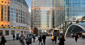 People walking in Canary Wharf with One Canada Square in the background