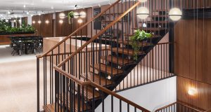 The stairwell with some coworking desks at One Canada Square in the background