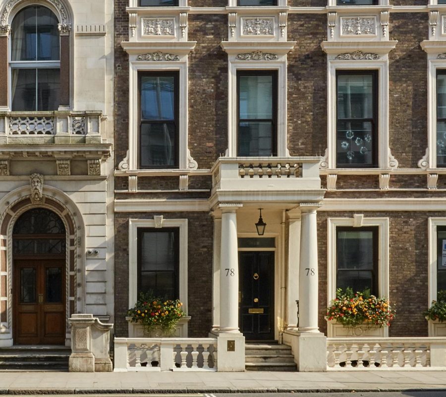 The front elevation of the office space on Pall Mall complete with white stucco , window boxes and other distinct features
