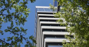 Shot looking up at One Lyric Square with leaves in the foreground