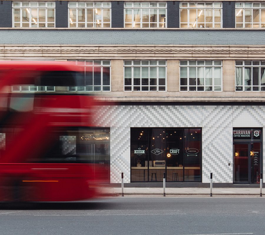 A London bus passing by the stylish office space on Whitechapel High Street