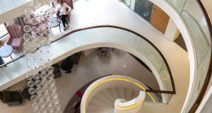 Looking down at the spiral staircase and chandelier at the outstanding office space in London on Kensington High Street