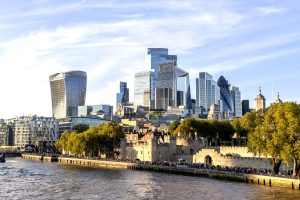 A view of office skyscrapers in the City of London from the Thames with the Tower of London in the foreground